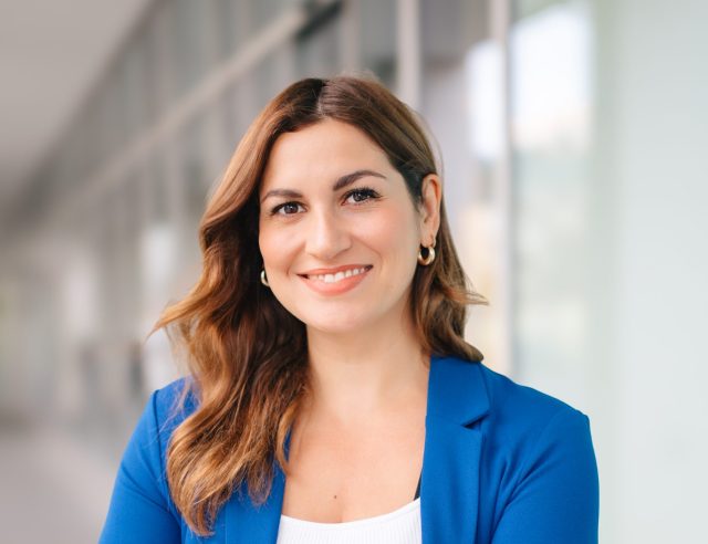 Rebecca Kennedy Portrait Professional portrait of Rebecca Kennedy smiling with crossed arms.
