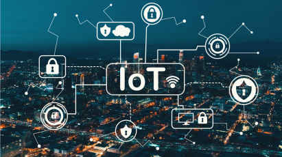 
A stylized graphic of the letters IoT (Internet of Things) with a Wi-Fi symbol, overlaying a dark, illuminated cityscape at night. Surrounding the text are interconnected white security icons, including locks, shields, a secure cloud, and secured devices.