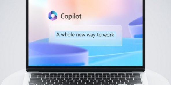 Laptop displaying the Copilot interface with the Copilot logo and tagline 'A whole new way to work' on a gradient blue and purple background.