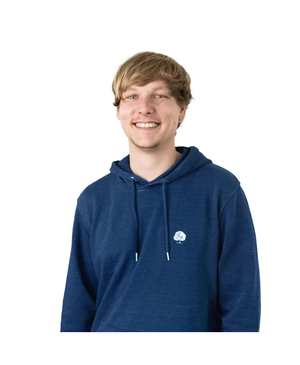 
A headshot of a smiling man with blonde hair, wearing a dark blue hoodie with a small white tree logo on the chest, set against a plain light gray background.