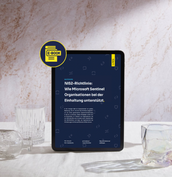 Tablet mit einem deutschen E-Book mit dem Titel „NIS2-Richtlinie: Wie Microsoft Sentinel Organisationen bei der Einhaltung unterstützt” auf einer Marmorfläche, flankiert von Kristallglaswaren, mit einem E-Book-Symbol, das auf digitale Inhalte hinweist.