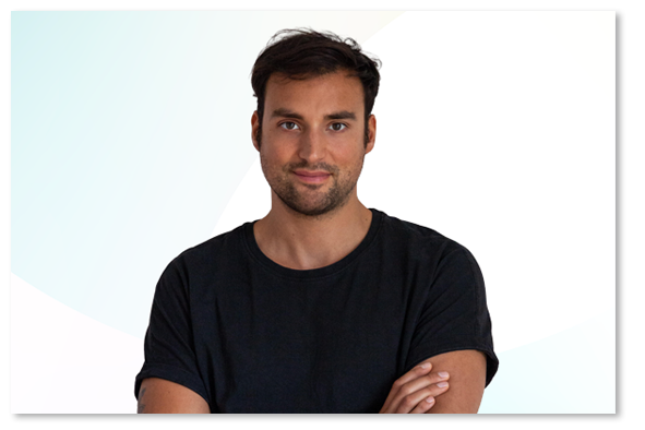 Oliver Gehrmann in a black T-shirt in front of a light blue and white background.