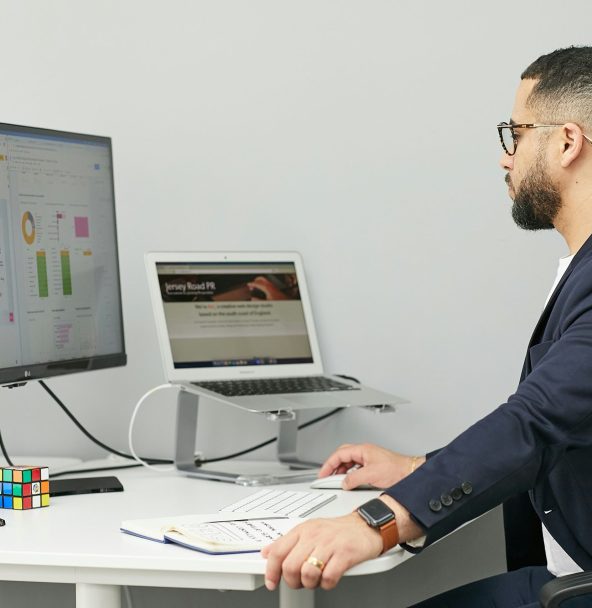 Man sitting at a computer and taking care of software quality assurance.